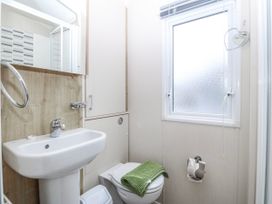 A bathroom with a sink and toilet at Seaviews in Nefyn