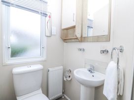 A bathroom with a toilet and sink at Seaviews Nefyn