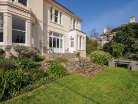 A garden area with stone steps and outdoor seating at Duncombe in Teignmouth
