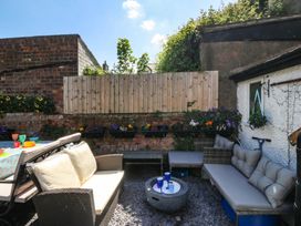 A garden seating area with a table and chairs at Yr Angor (The Anchor) Llandudno Junction