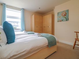 A bedroom with a bed and wardrobe at Whitewater Seaview in Newquay