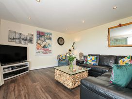 A living room with a sofa and television at Whitewater Seaview in Newquay