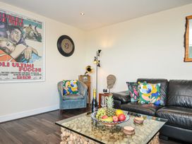 A living room with a couch and a table with fruit at Whitewater Seaview in Newquay