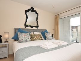 A bedroom with a bed and decorative pillows at Whitewater Seaview in Newquay