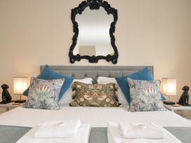 A bedroom with a bed and decorative pillows at Whitewater Seaview in Newquay