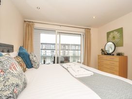 A bedroom with a bed and dresser at Whitewater Seaview in Newquay
