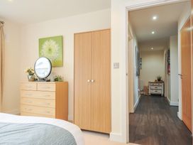 A bedroom with a dresser and mirror at Whitewater Seaview in Newquay