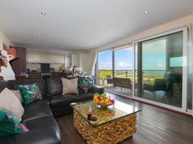 A living room with a sofa and coffee table at Whitewater Seaview in Newquay