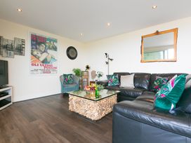 A living room with a sofa and coffee table at Whitewater Seaview in Newquay