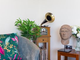 A living room featuring a gramophone, potted plant and sculpture at Whitewater Seaview in Newquay