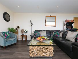 A living room with a sofa and a coffee table at Whitewater Seaview in Newquay