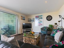 A living room with a coffee table and television at Whitewater Seaview in Newquay