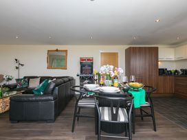A living room with a dining table set at Whitewater Seaview in Newquay