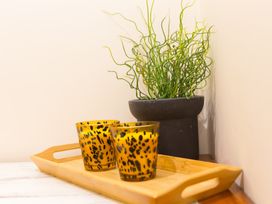 A tray with candles and a plant in a pot at Whitewater Seaview in Newquay