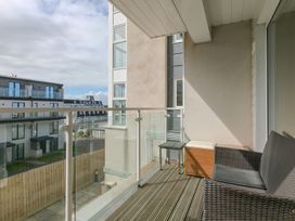 A balcony with a table and chairs at Whitewater Seaview in Newquay