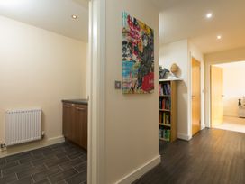 A hallway with a bookshelf and cabinet at Whitewater Seaview, Newquay