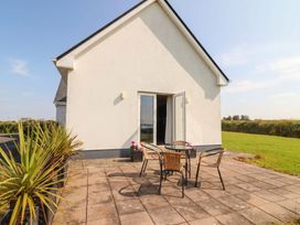 An outdoor seating area with table and chairs at The Boathouse in Carrigaholt, County Clare
