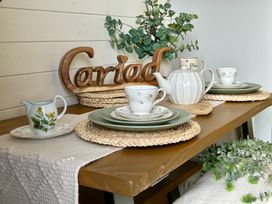 A dining room table set with tea service and decor at Willow in Llangurig near Llanidloes