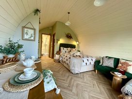 A bedroom with a bed and couch at Willow in Llangurig near Llanidloes