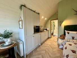 A studio with a kitchen unit and bed at Willow in Llangurig near Llanidloes