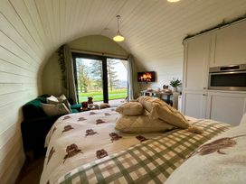A bedroom with bed and sofa at Willow, Llangurig near Llanidloes