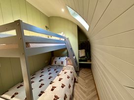 A bedroom with a bunk bed and a double bed at Willow in Llangurig near Llanidloes