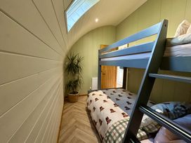 A bedroom with a bunk bed and plant at Willow in Llangurig near Llanidloes