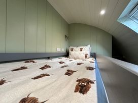 A bedroom with a bed and pillows at Willow Llangurig near Llanidloes