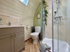 A bathroom with a shower, toilet, and sink at Willow in Llangurig near Llanidloes