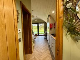 A hallway with access to a kitchen and a view outside at Willow Llangurig near Llanidloes