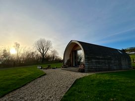 A pod-shaped building with a pathway in front at Willow in Llangurig near Llanidloes