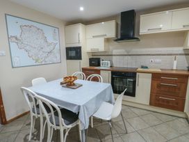 A kitchen with a table and chairs at Ty Haf in Trearddur Bay