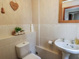 A bathroom with a toilet and sink at Ty Haf in Trearddur Bay
