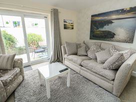 A living room with a sofa and coffee table at Ty Haf in Trearddur Bay