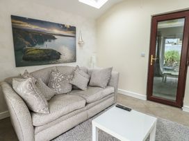 A living room with a sofa and coffee table at Ty Haf in Trearddur Bay
