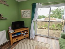 A living room with a television and a sofa at Flodden Apartment in Wooler