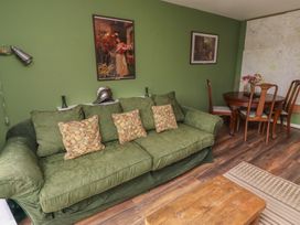 A living room with a sofa and dining table at Flodden Apartment in Wooler