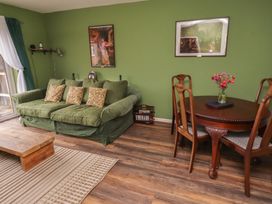A living room with a sofa and dining table at Flodden Apartment in Wooler