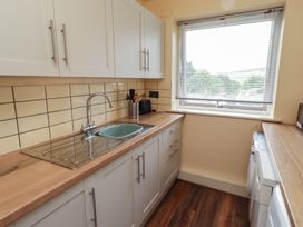 A kitchen with a sink and kitchen cabinets at Flodden Apartment in Wooler