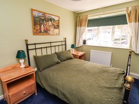 A bedroom with a bed and nightstands at Flodden Apartment in Wooler
