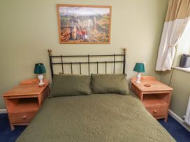 A bedroom with a bed and bedside tables at Flodden Apartment in Wooler