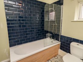 A bathroom with a bathtub and toilet at Flodden Apartment in Wooler