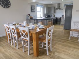 A dining room with a table set for a meal at Fair View in St Just in Roseland near St Mawes