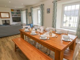 A dining area with a large table set for a meal at Fair View St Just in Roseland near St Mawes