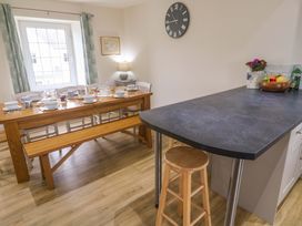 A kitchen with a dining table set for a meal at Fair View in St Just in Roseland near St Mawes