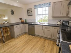 A kitchen with a sink and dishwasher at Fair View in St Just in Roseland near St Mawes