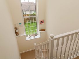 A staircase with artwork and a window at Fair View St Just in Roseland near St Mawes
