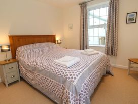 A bedroom with a bed and nightstand at Fair View St Just in Roseland near St Mawes