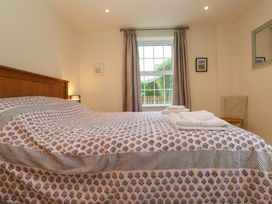 A bedroom with a bed and window at Fair View in St Just in Roseland near St Mawes