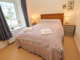 A bedroom with a bed and bedside table at Fair View St Just in Roseland near St Mawes